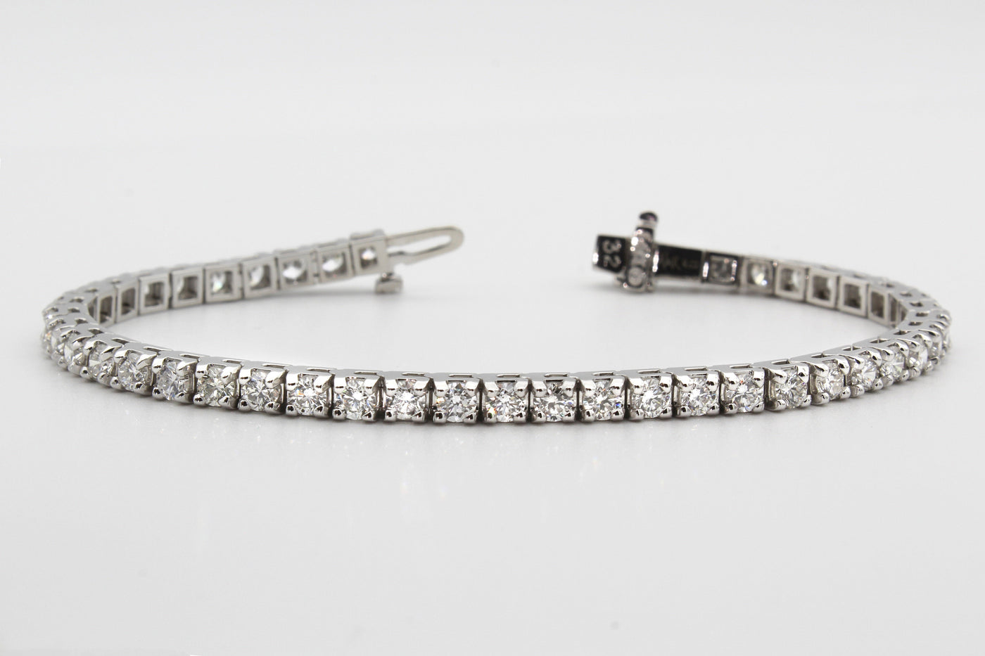 silver lab grown diamond tennis bracelet on grey background